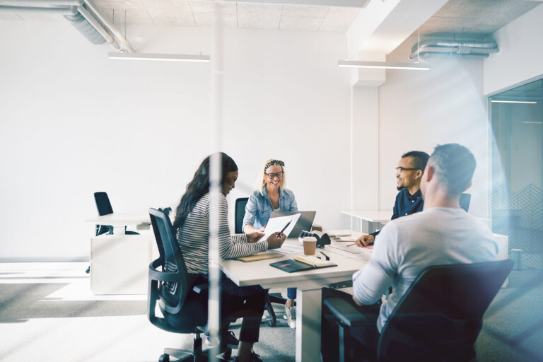 Friendly team fully focused on client needs during a positive office meeting