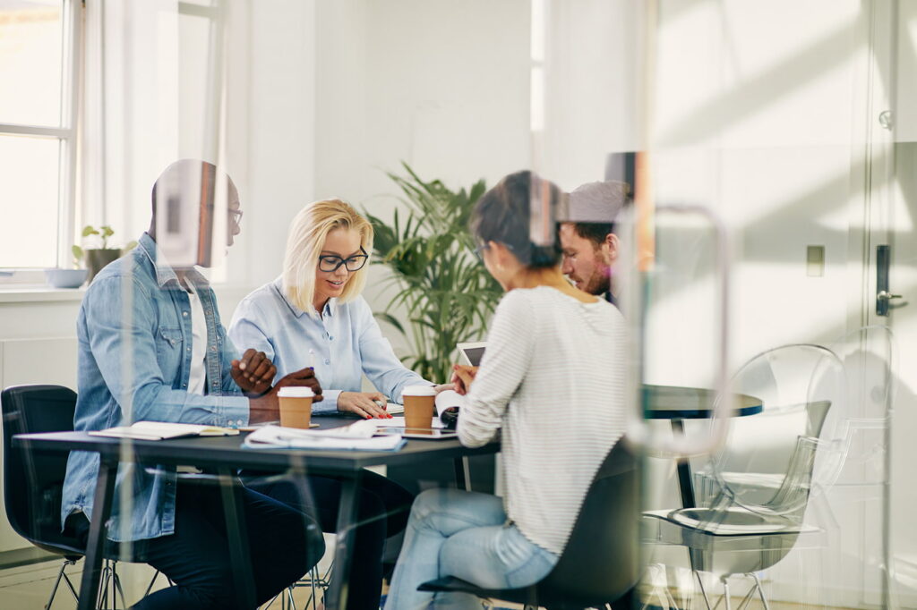 Friendly professionals gathered for a business meeting, ready to discuss your needs