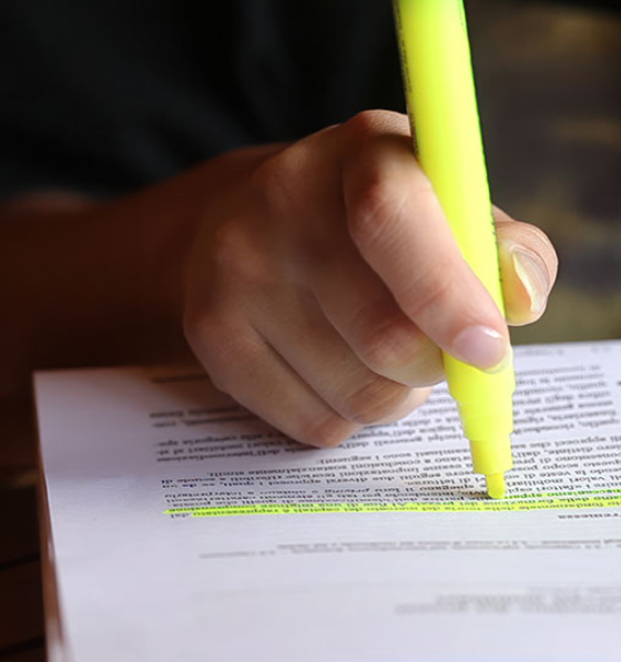 Proofreading and highlighting a document with a yellow highlighter